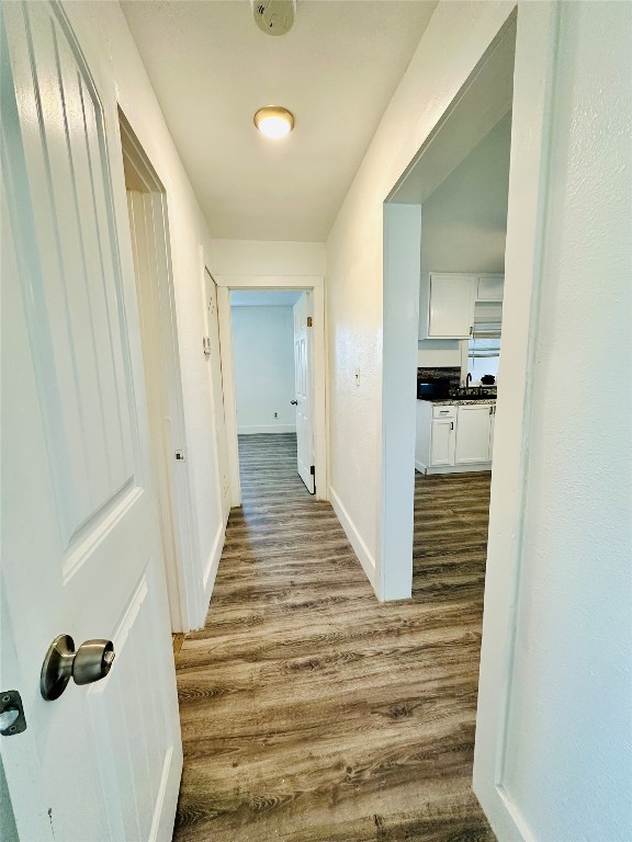 corridor featuring hardwood / wood-style floors