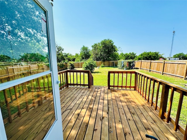 wooden deck featuring a lawn