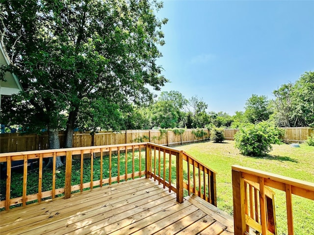 wooden deck with a lawn