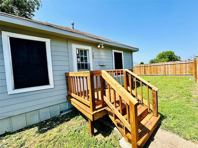 wooden deck featuring a yard