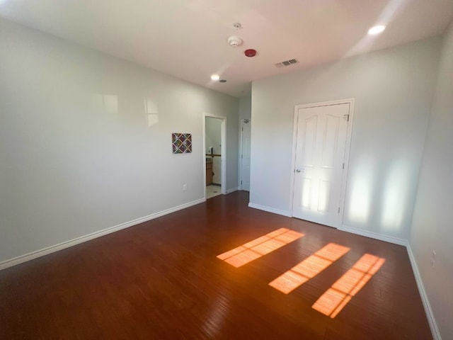 unfurnished room with hardwood / wood-style floors