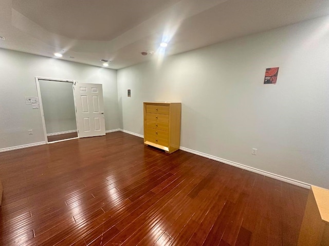 spare room with dark wood-type flooring