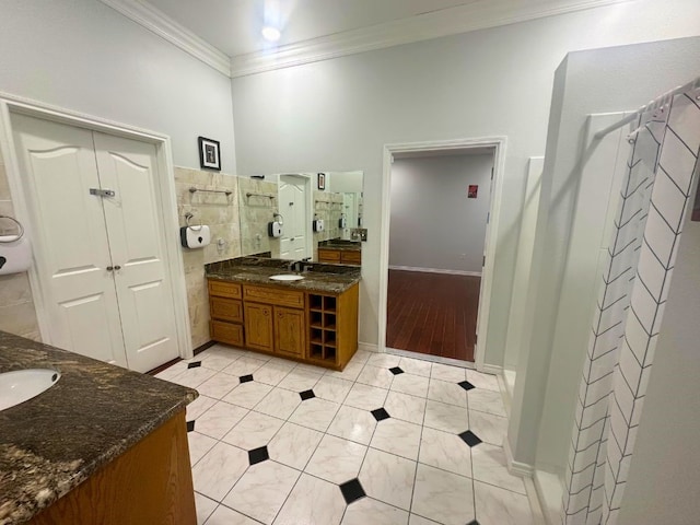 bathroom with tile floors, ornamental molding, and vanity