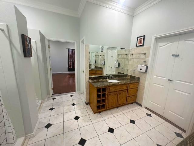 bathroom featuring tile floors, ornamental molding, and oversized vanity