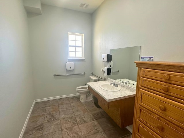 bathroom with vanity, toilet, and tile floors