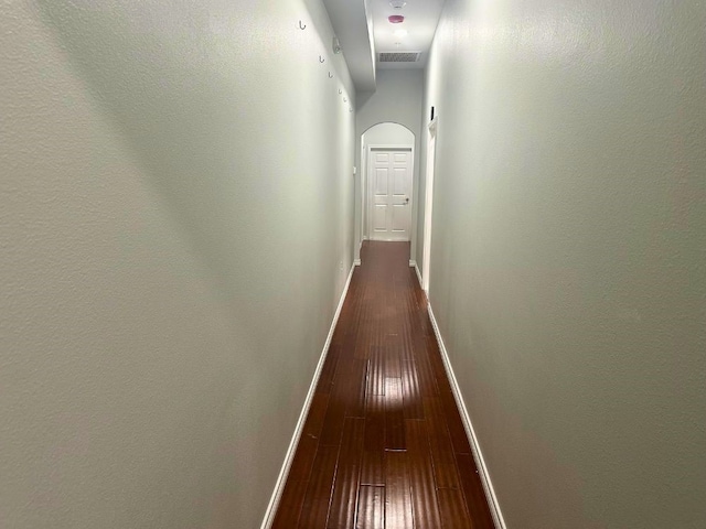 corridor with hardwood / wood-style flooring