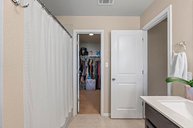 bathroom with tile patterned flooring and vanity