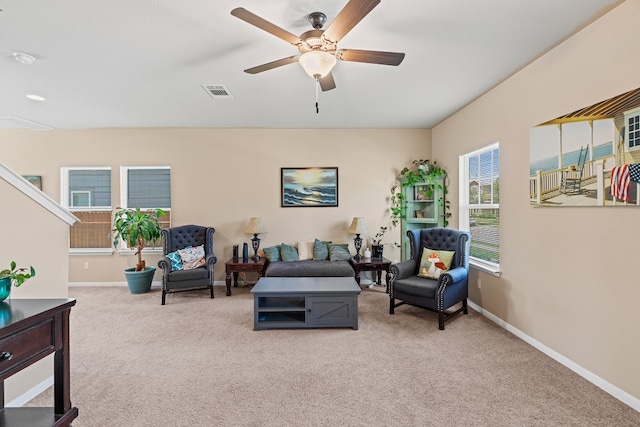 living room with ceiling fan and light colored carpet