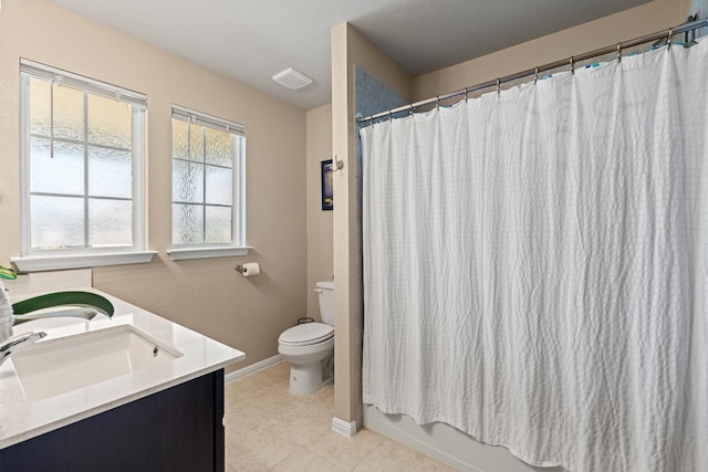 bathroom featuring tile patterned flooring, vanity, and toilet