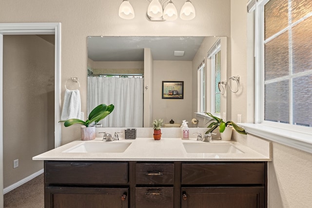 212 Timber Brook Dr, Hutto, TX 78634 - bathroom featuring a sink, double vanity, and a shower with shower curtain