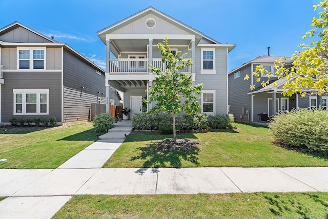 view of front of house with a balcony and a front yard