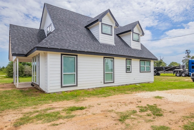 rear view of property with a lawn