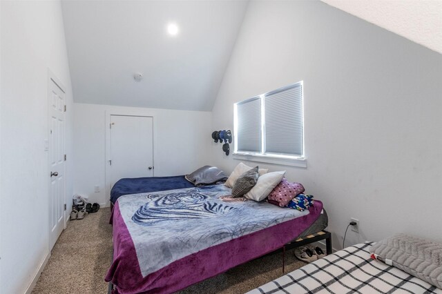 bedroom with vaulted ceiling and carpet floors