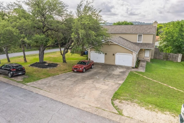 view of front of home featuring fence, driveway, roof with shingles, a chimney, and a front yard