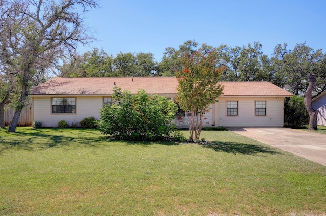 ranch-style home featuring a front yard