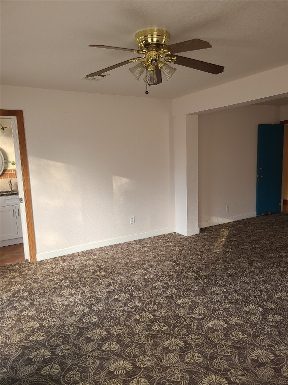 spare room featuring sink and ceiling fan