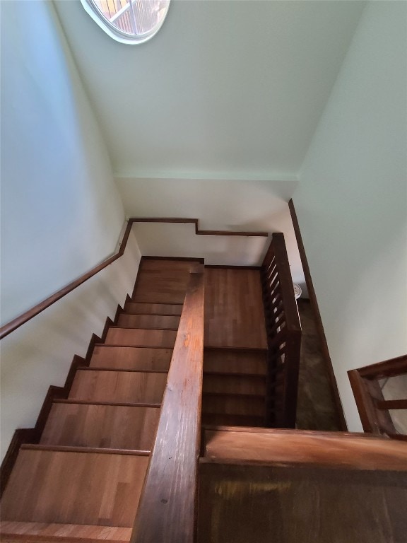 stairs featuring dark wood-type flooring