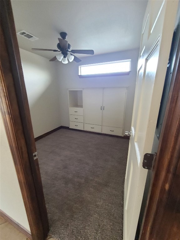 unfurnished room featuring ceiling fan and carpet floors