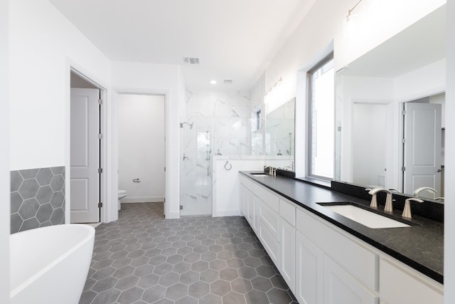 full bathroom featuring plus walk in shower, vanity, toilet, and tile patterned flooring