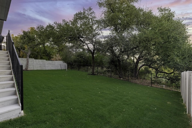 view of yard at dusk