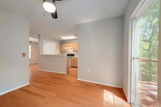 unfurnished living room with ceiling fan and light hardwood / wood-style floors