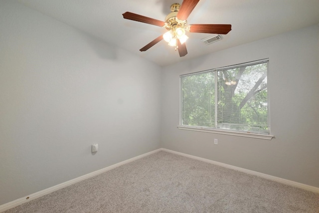 spare room with plenty of natural light, ceiling fan, and carpet floors