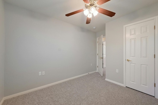 unfurnished bedroom featuring ceiling fan and light carpet