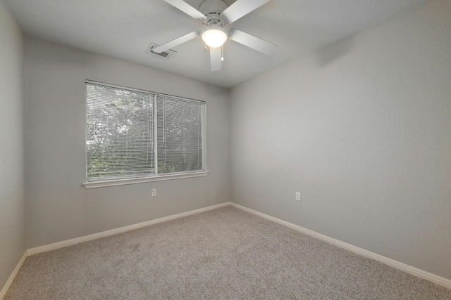 spare room featuring carpet flooring and ceiling fan