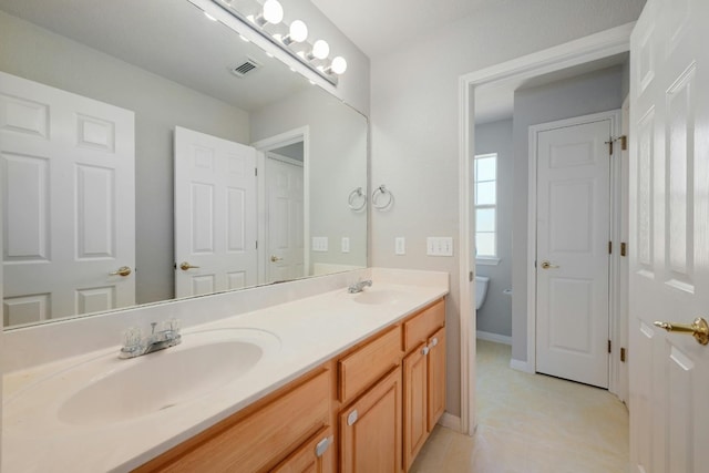 bathroom featuring vanity and toilet