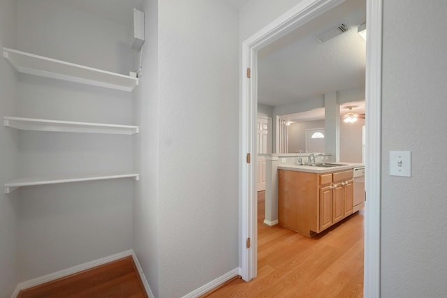 hall featuring sink and light hardwood / wood-style flooring