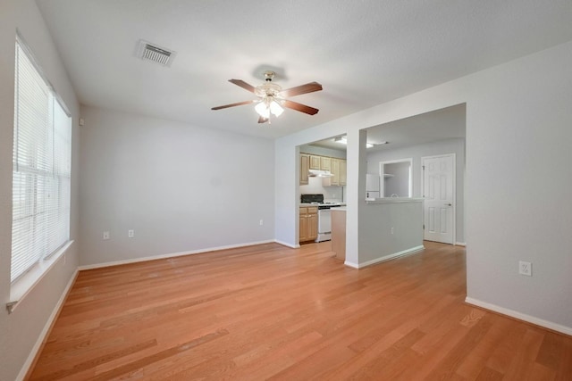 unfurnished living room featuring light hardwood / wood-style flooring and ceiling fan