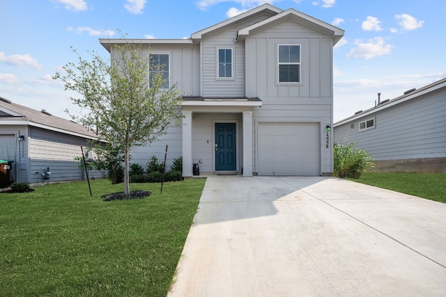 view of property with a front yard and a garage