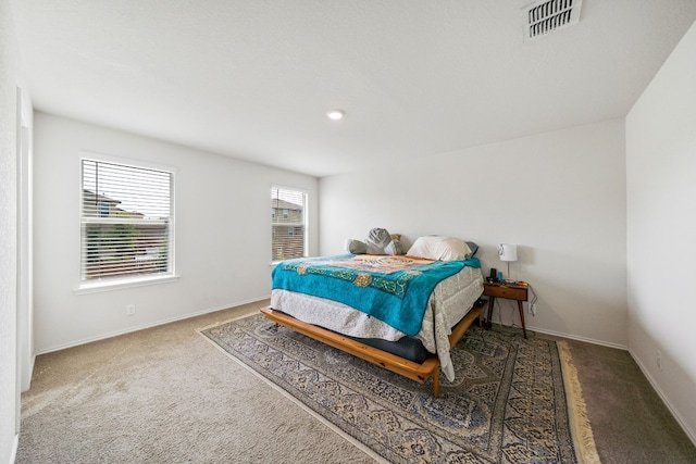 bedroom featuring dark carpet