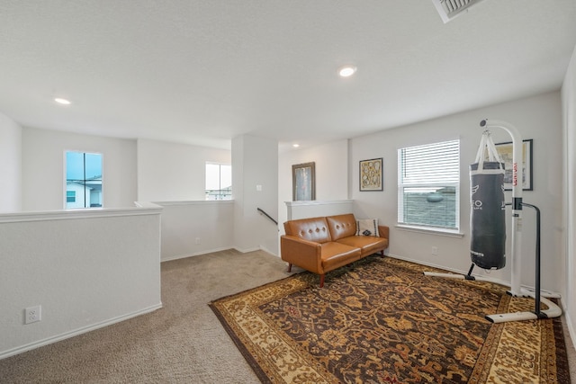 sitting room featuring a healthy amount of sunlight and carpet floors