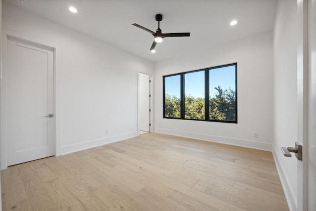 empty room featuring ceiling fan and light hardwood / wood-style flooring