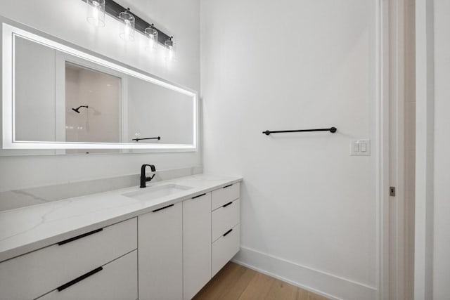 bathroom featuring a shower, vanity, and wood-type flooring