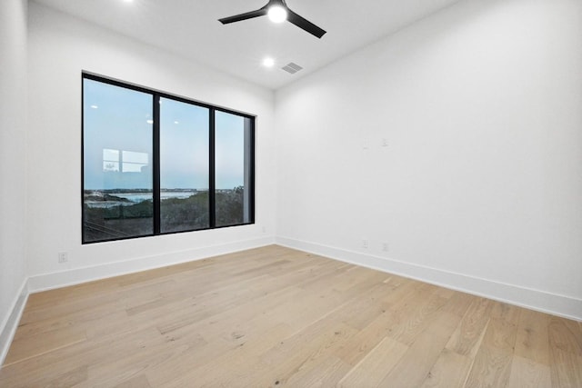 spare room featuring ceiling fan and light hardwood / wood-style flooring