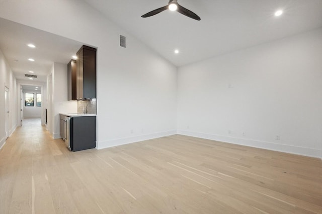 unfurnished room with light wood-type flooring, ceiling fan, and lofted ceiling