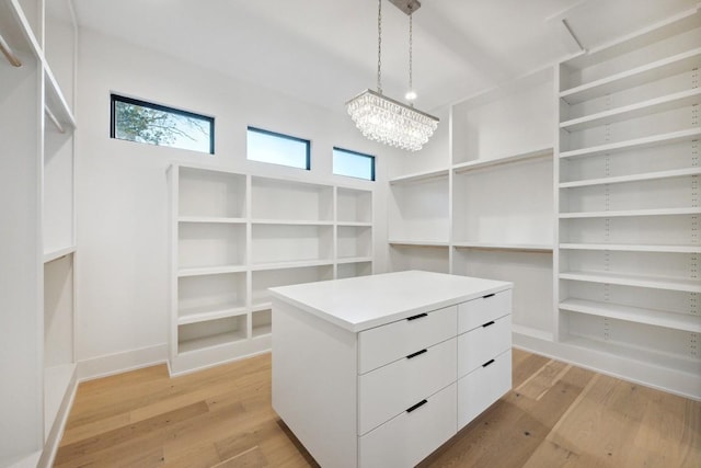 18116 Cedar Sage Ct, Lago Vista, TX 78645 - walk in closet with light wood finished floors and a chandelier