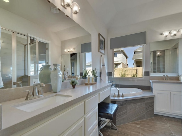 bathroom featuring tile floors, independent shower and bath, and large vanity