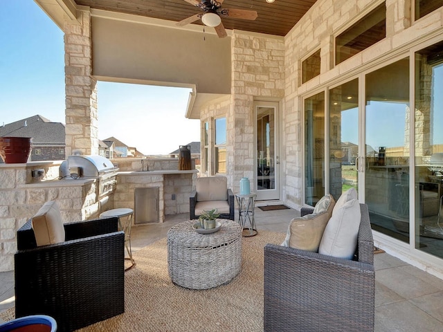 view of patio featuring exterior kitchen, ceiling fan, and grilling area