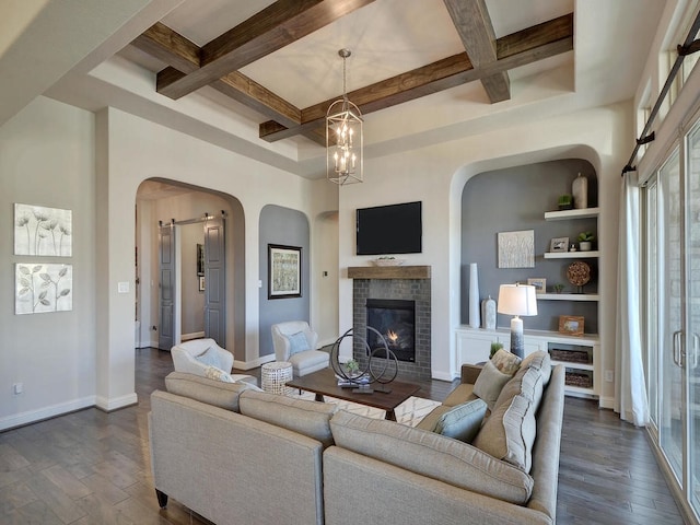 living room featuring beamed ceiling, a fireplace, dark wood-type flooring, built in features, and coffered ceiling