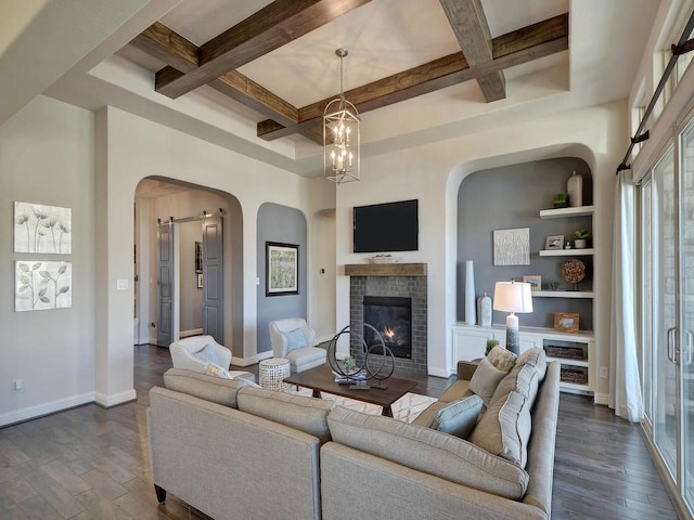 20517 Martin Ln, Pflugerville, TX 78660 - living room featuring arched walkways, coffered ceiling, dark wood-type flooring, a tiled fireplace, and beamed ceiling