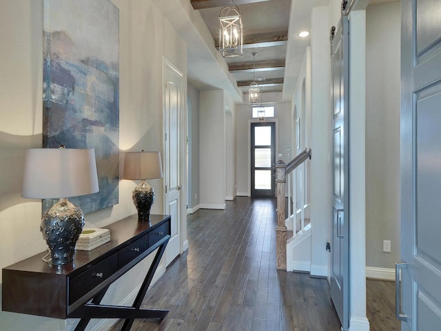 foyer entrance with beam ceiling, a chandelier, and dark wood-type flooring