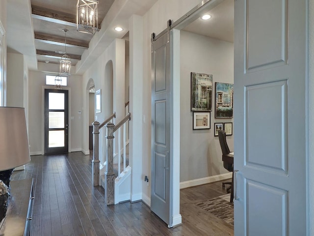 20517 Martin Ln, Pflugerville, TX 78660 - foyer featuring baseboards, a barn door, dark wood-style floors, stairs, and a chandelier