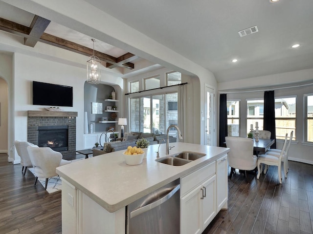20517 Martin Ln, Pflugerville, TX 78660 - kitchen featuring stainless steel dishwasher, a sink, open floor plan, coffered ceiling, and dark wood-type flooring