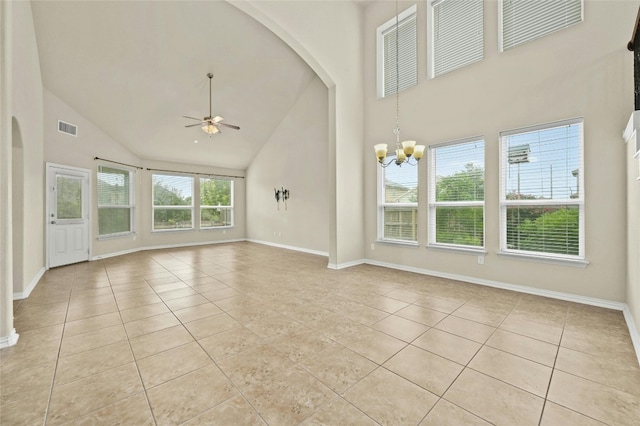 unfurnished living room featuring light tile patterned floors, ceiling fan with notable chandelier, and high vaulted ceiling