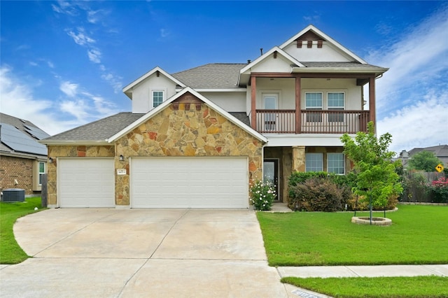 view of front of home featuring central AC, a garage, a balcony, and a front lawn