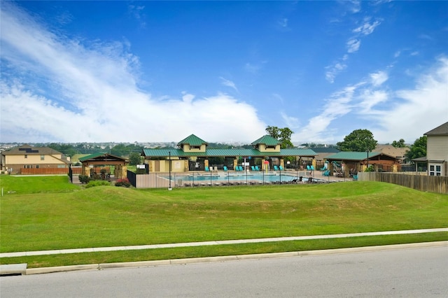 view of home's community with a gazebo, a pool, and a yard