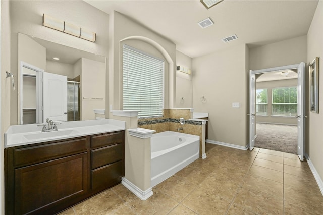 bathroom featuring vanity and shower with separate bathtub